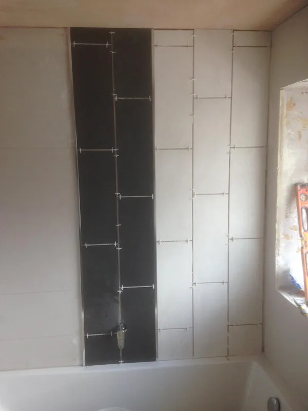 Black tile feature bath installation before Kent