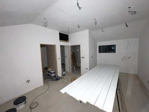 Walls and ceilings, boarded, electrics in, white washed on a conversion project in Kent