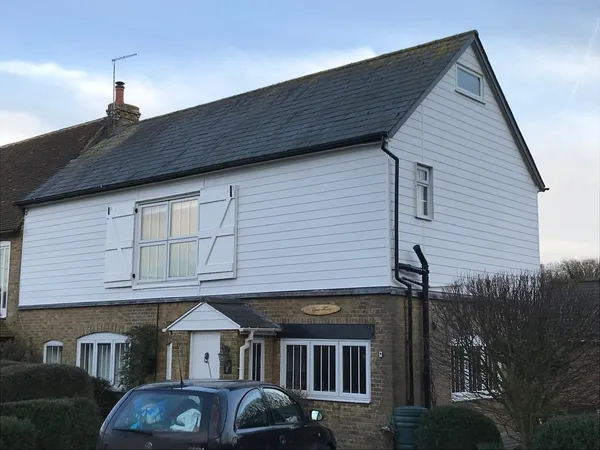 Exterior cladding project fully installed with white painted shutters Kent