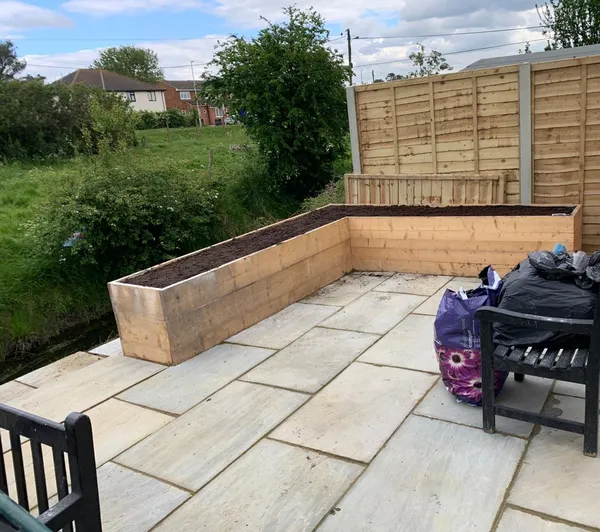 Grey patio installation and planter build on a local landscaping project in Kent