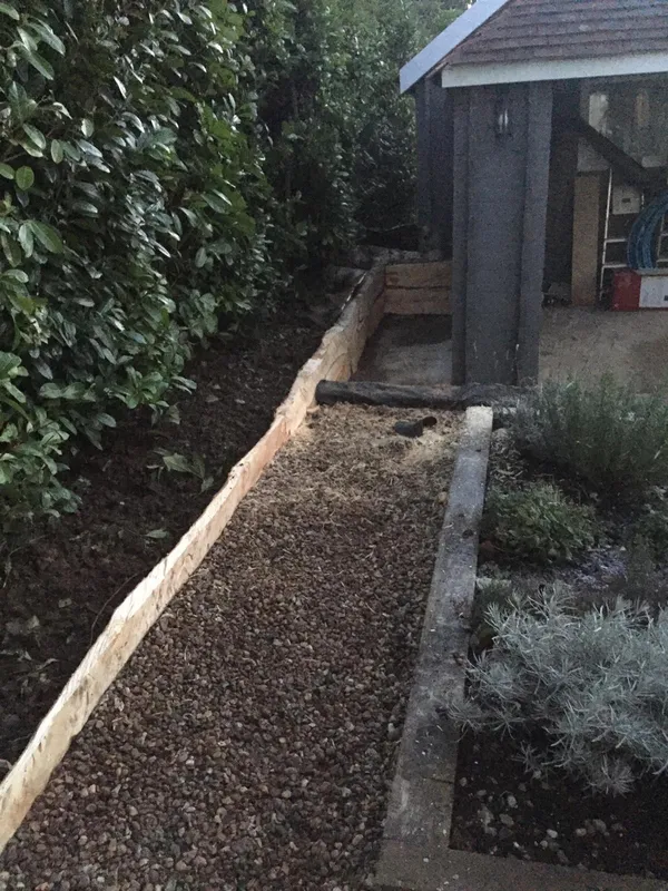 Gravel pathway down the side of the summer house
