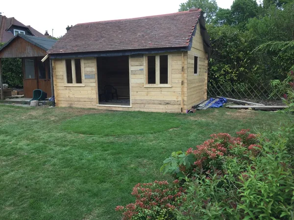 Roof tile installation and window frames put in on the summer house custom build project