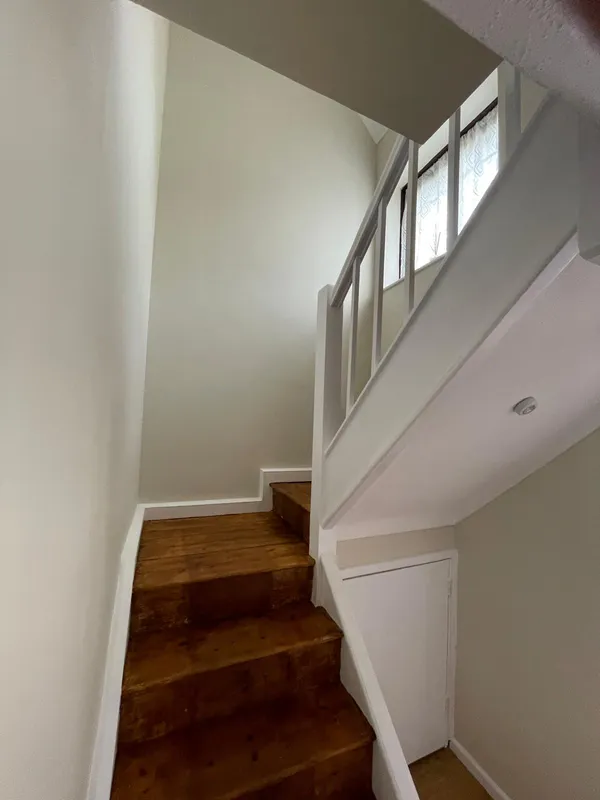 Cream painted walls on a staircase area on a painting and decorating project in Kent