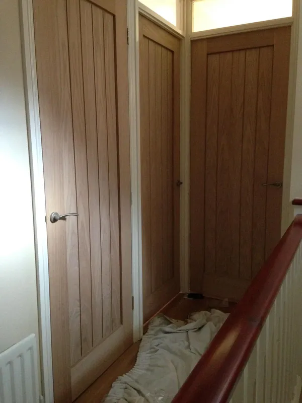 Straight panelled wood effect door installation for a decorating project in Kent