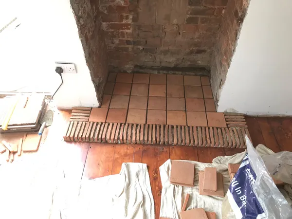 Terracotta tile installation in fire place for a local decorating project in Kent