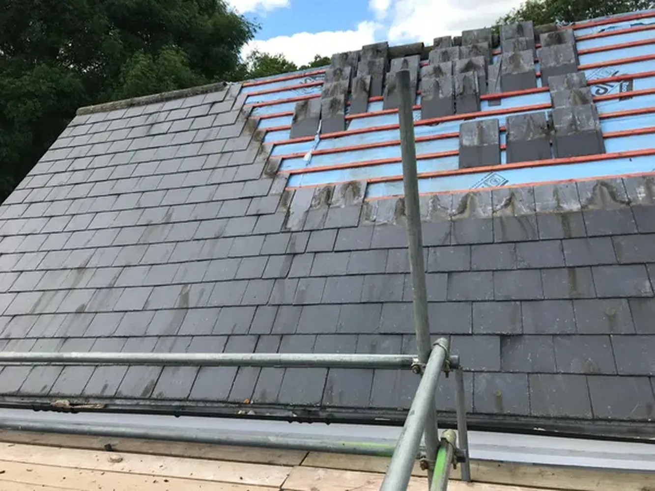 Slate roofing tiles and ridge tiles being installed on a roofing project in Kent