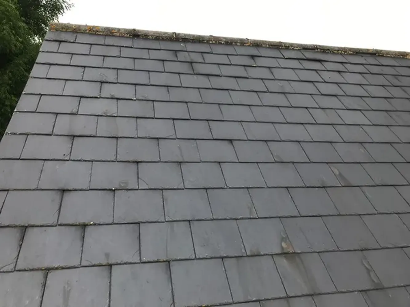 Slate roofing tiles being installed on a roofing project in Kent