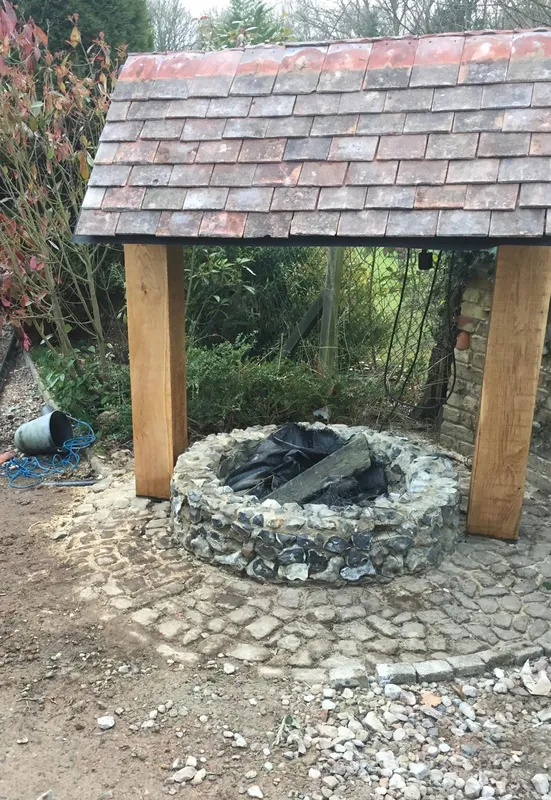 New posts and roof with tiles installation for a local well repair project, Kent