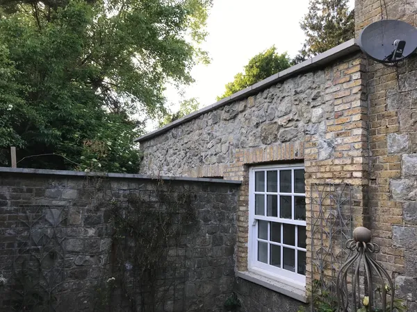 Slab installation on natural stone walls, part of local extension project, Kent