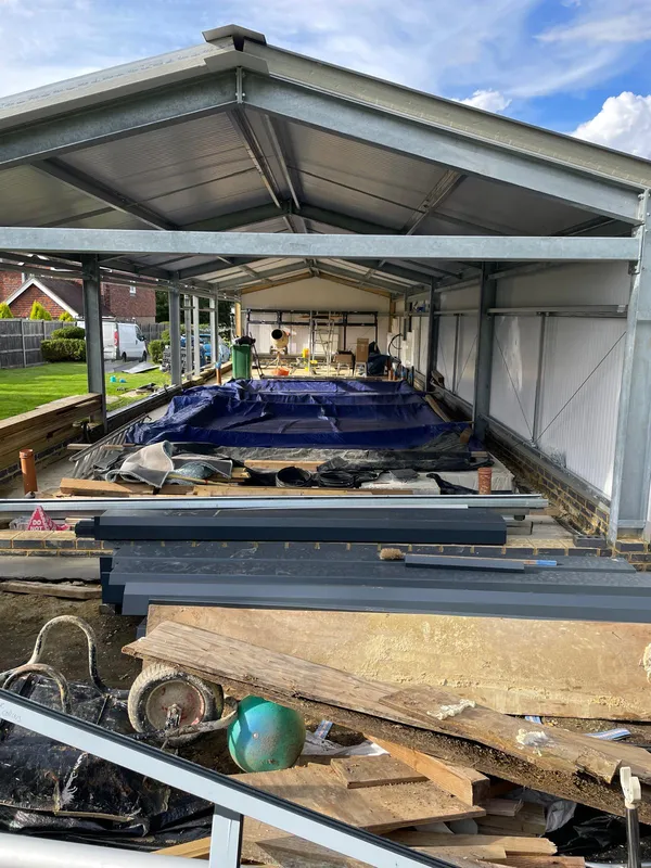 Roof and side installation of pool building, Ashford