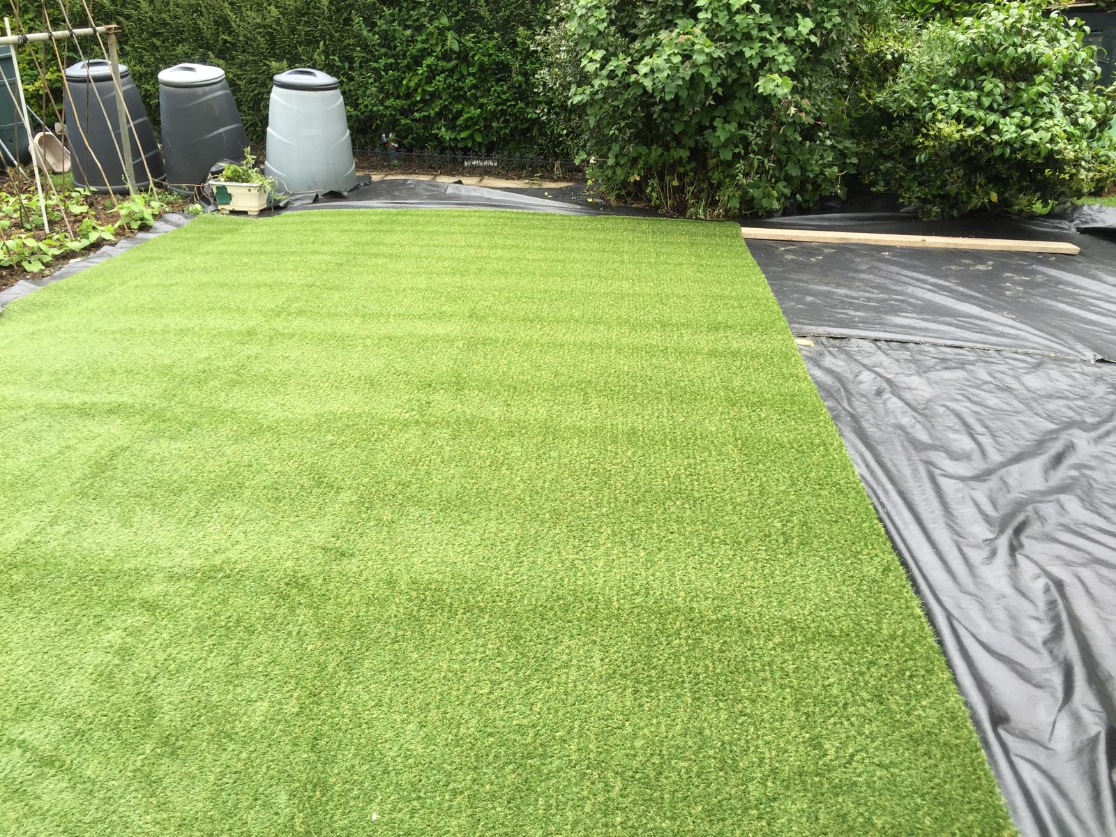 Artificial grass being installed for a local garden project