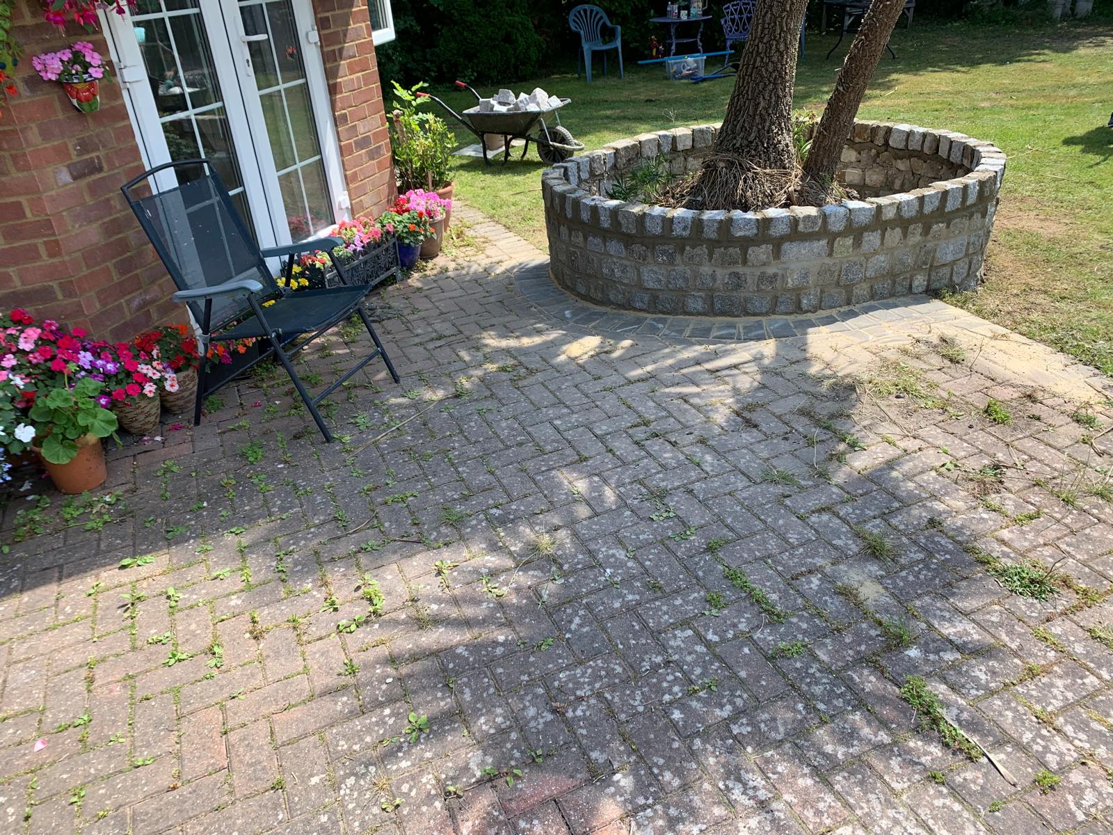 Back view of a natural stone curved wall installation for a landscaping project