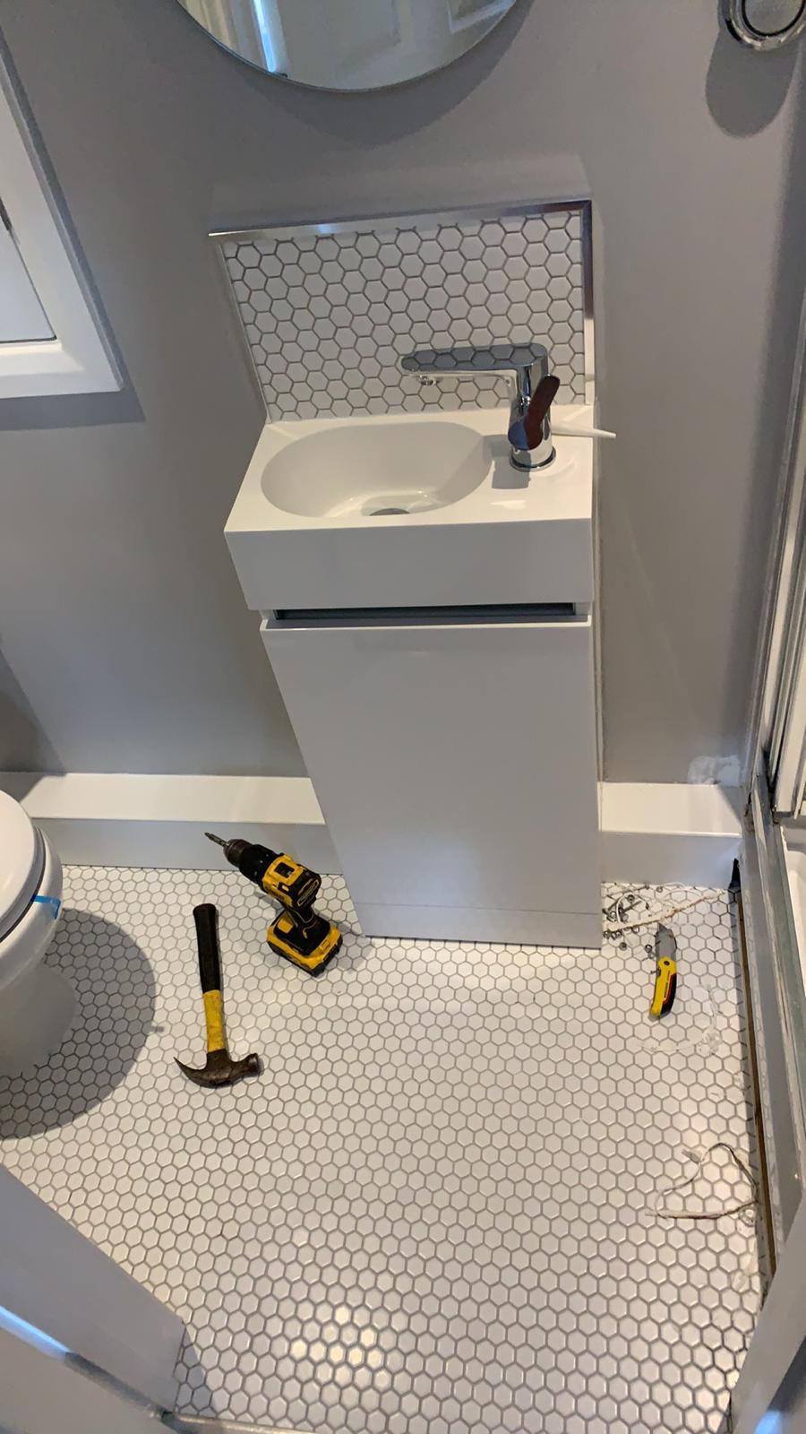 Bathroom project with white mosaic floor tile installation