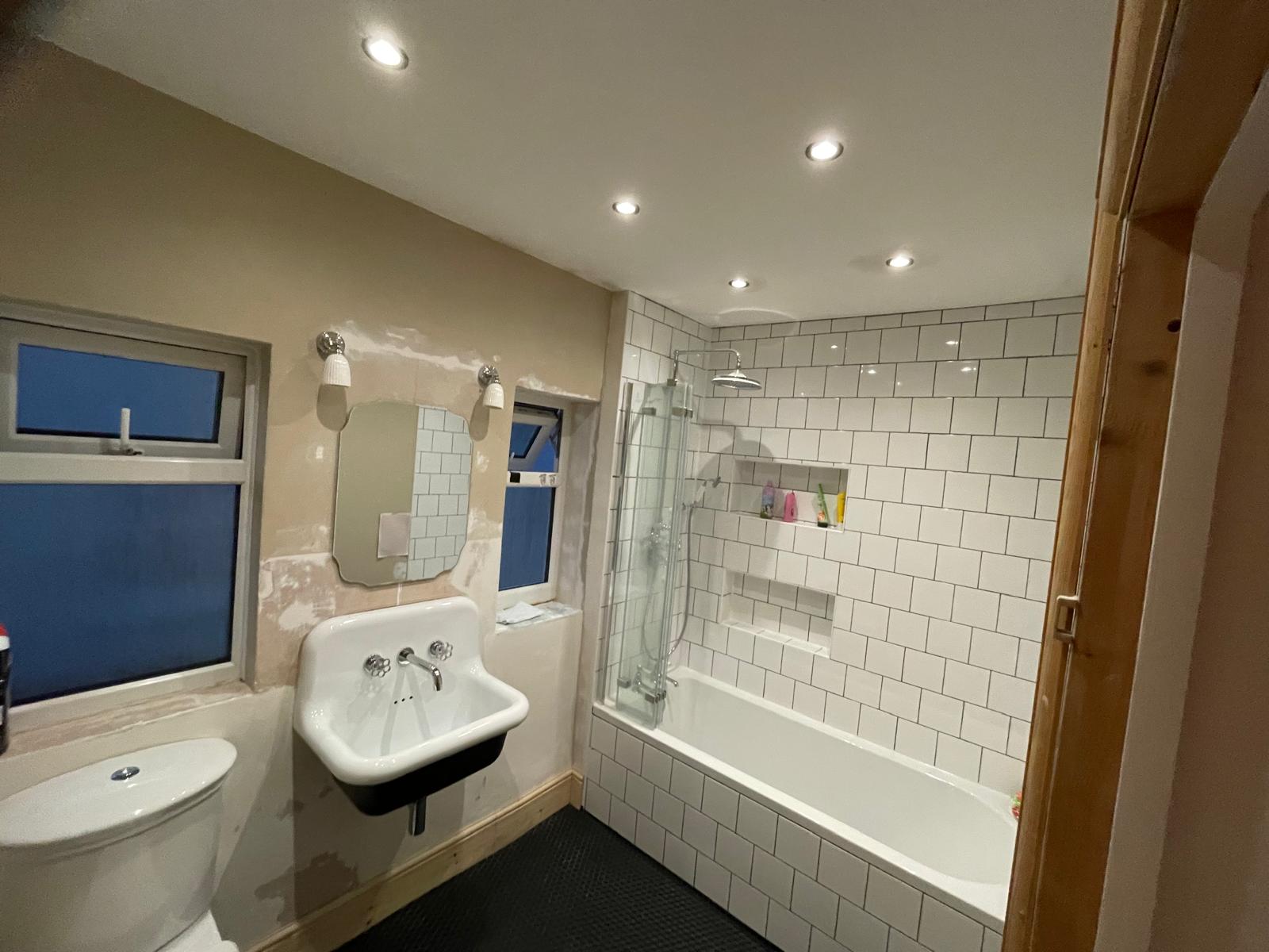 Bathroom re-fit project with white square wall tile 1
