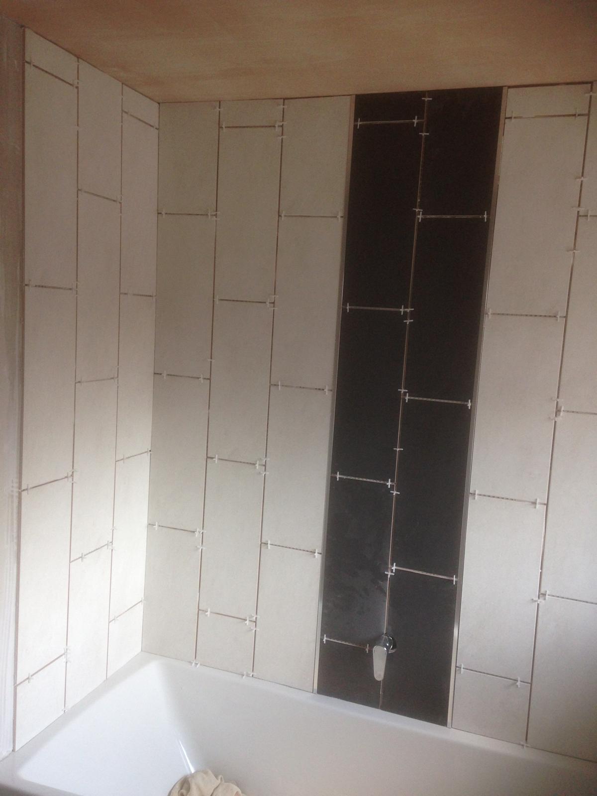 Black and white wall tile installation ready for grout 