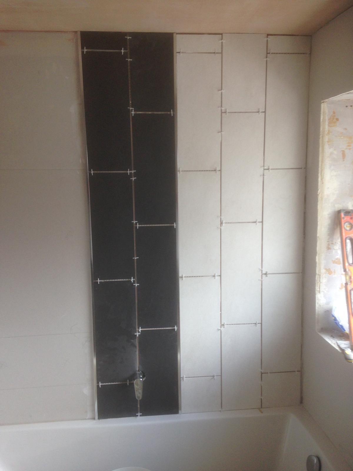 Black feature wall tile installation 