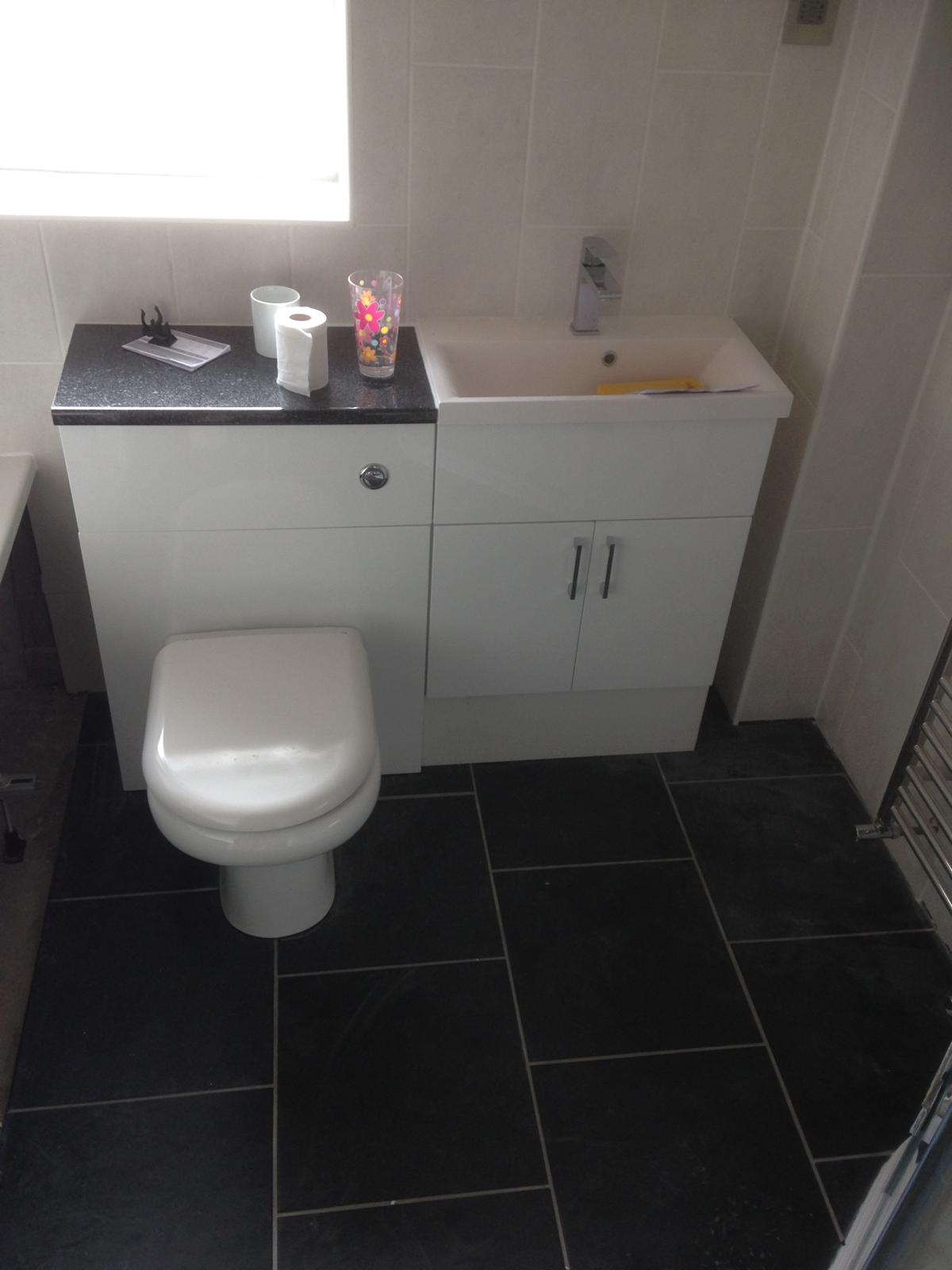 Black floor tile installation for a bathroom project in Kent