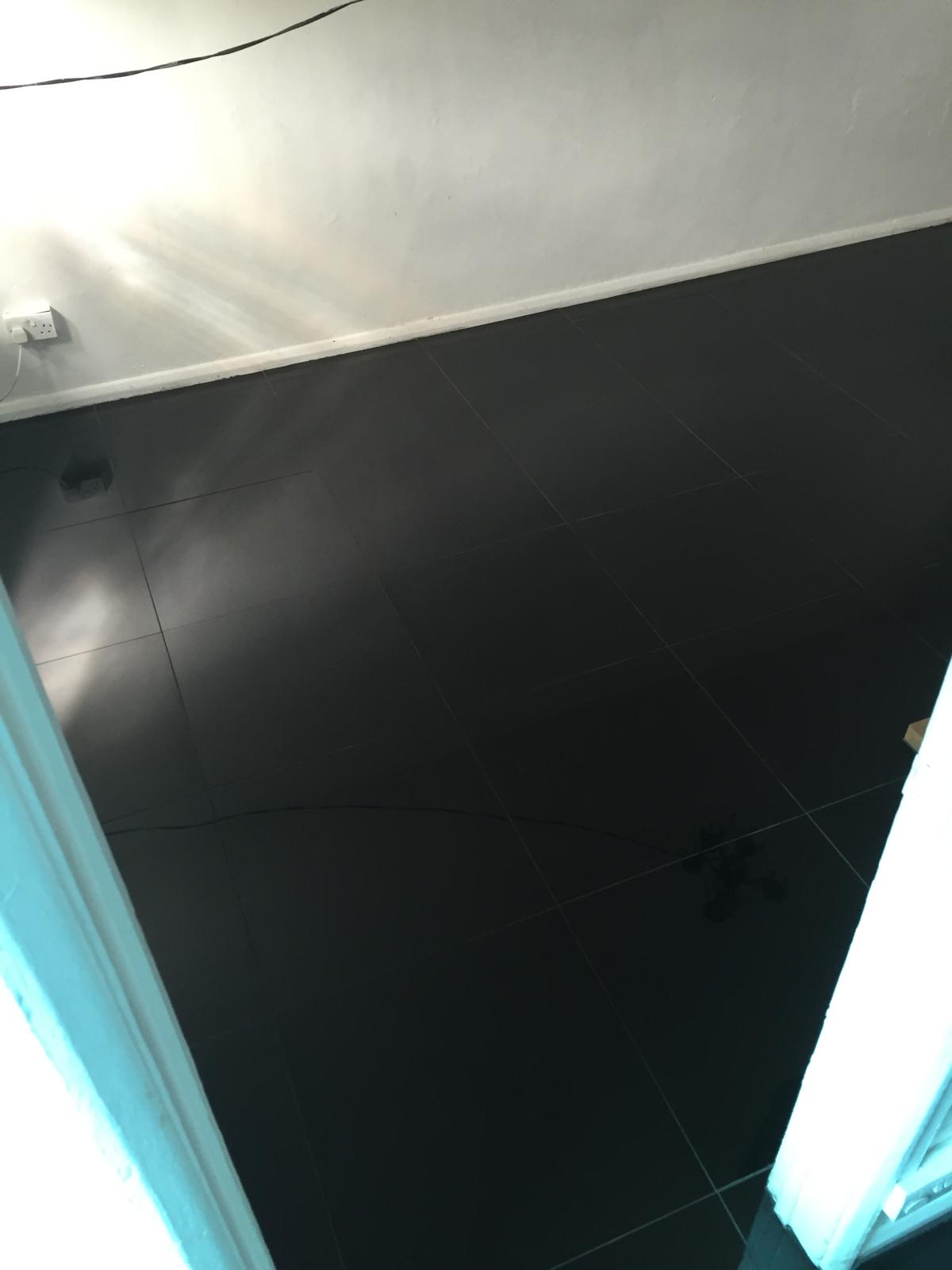 Black gloss porcelain tile installation for a local decorating project 