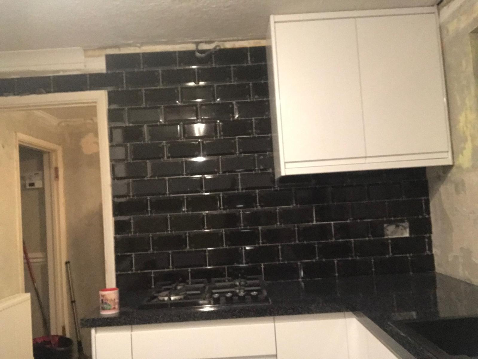 Black gloss tile installation for a kitchen project