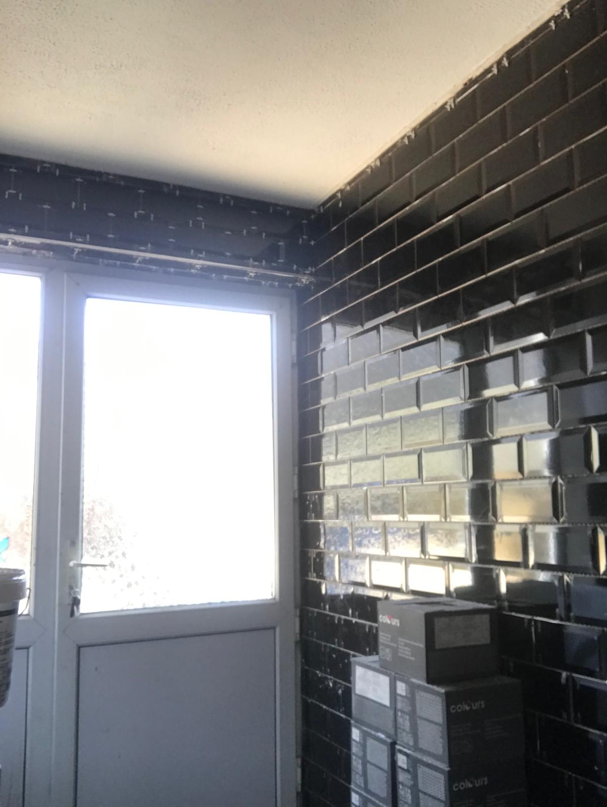 Black gloss wall tile installation