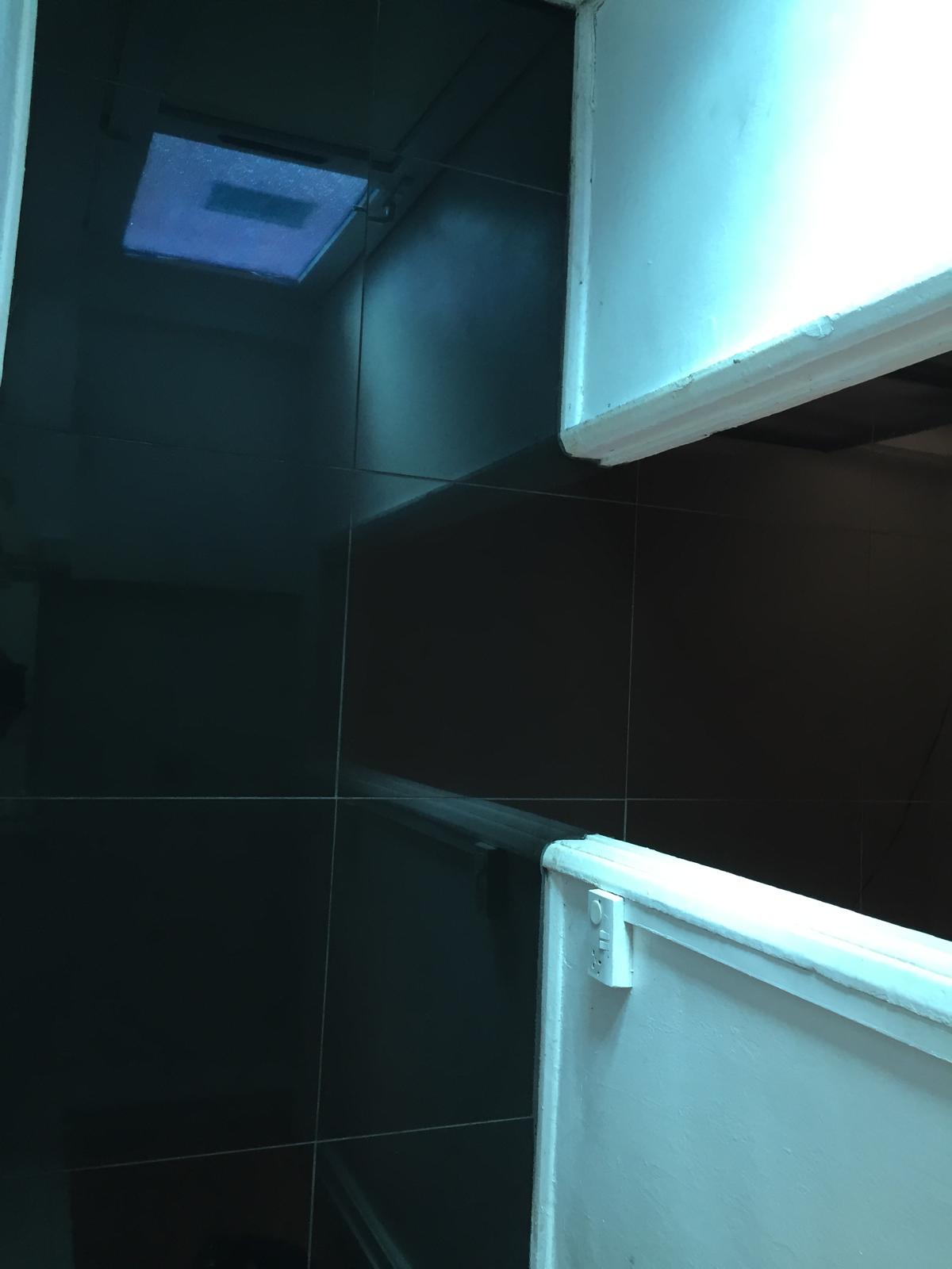 Black porcelain tile installation through doorway on a decorating project 