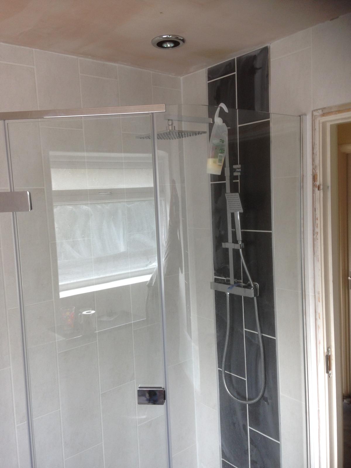 Black tile shower feature installation 