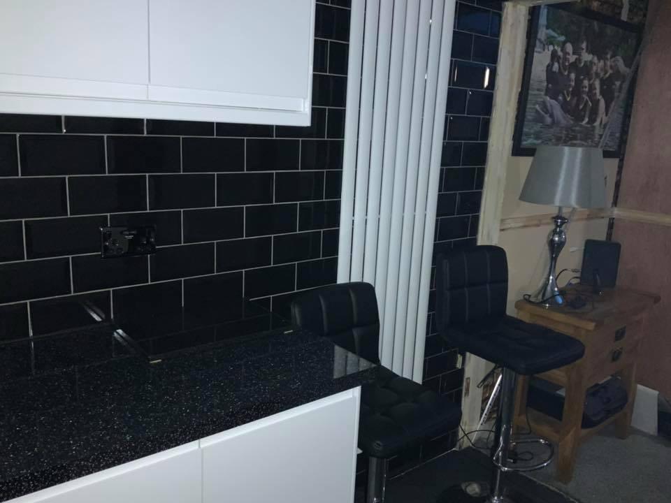 Black wall tile installation in kitchen for local project