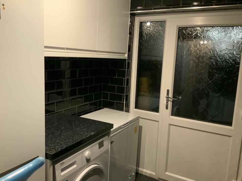 Black wall tile installation in kitchen on a local project