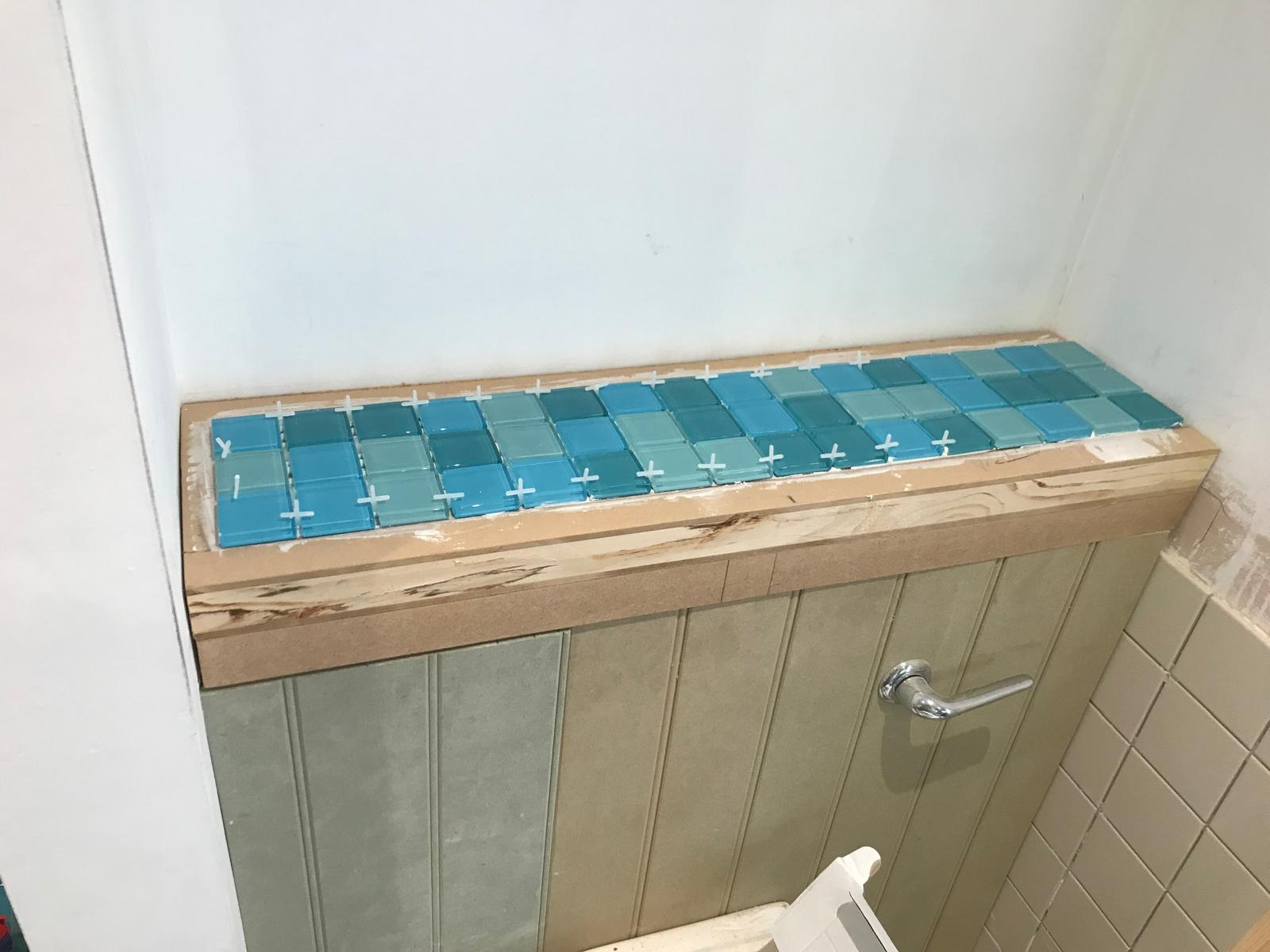 Blue mosaic tile on top of toilet cistern for a local bathroom project
