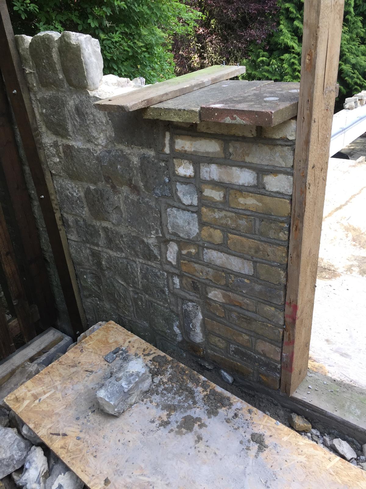 Brick and stone wall installation around door frame for local extension project