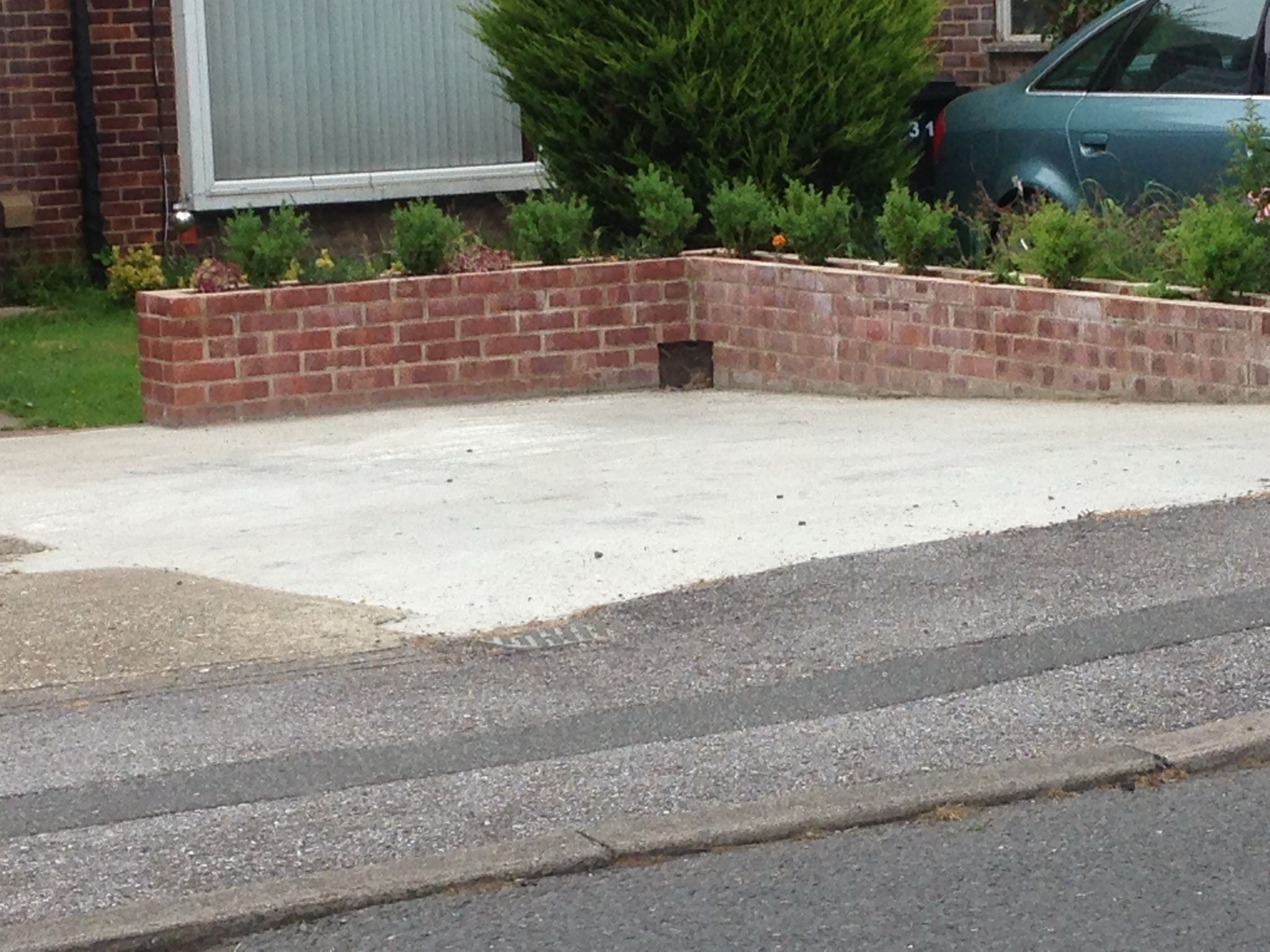 Brick wall installation on a driveway for a landscaping project in Kent