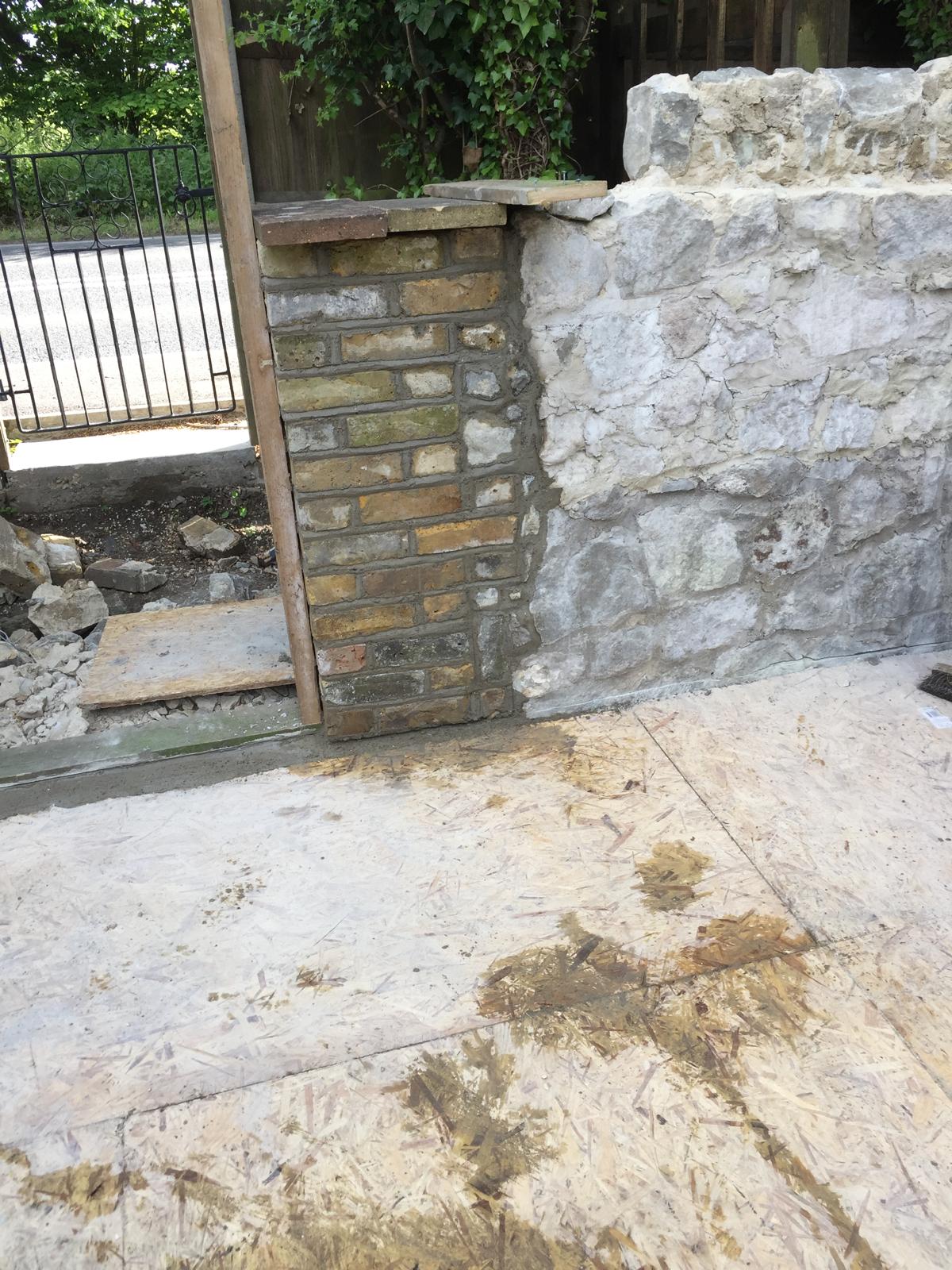 Brick wall installation against stone wall for an extension project in Kent