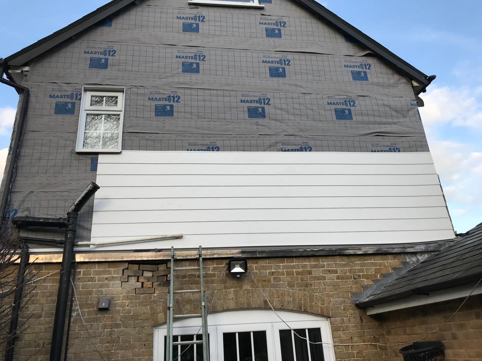 Cladding being installed on the side of a house for a local project in Kent