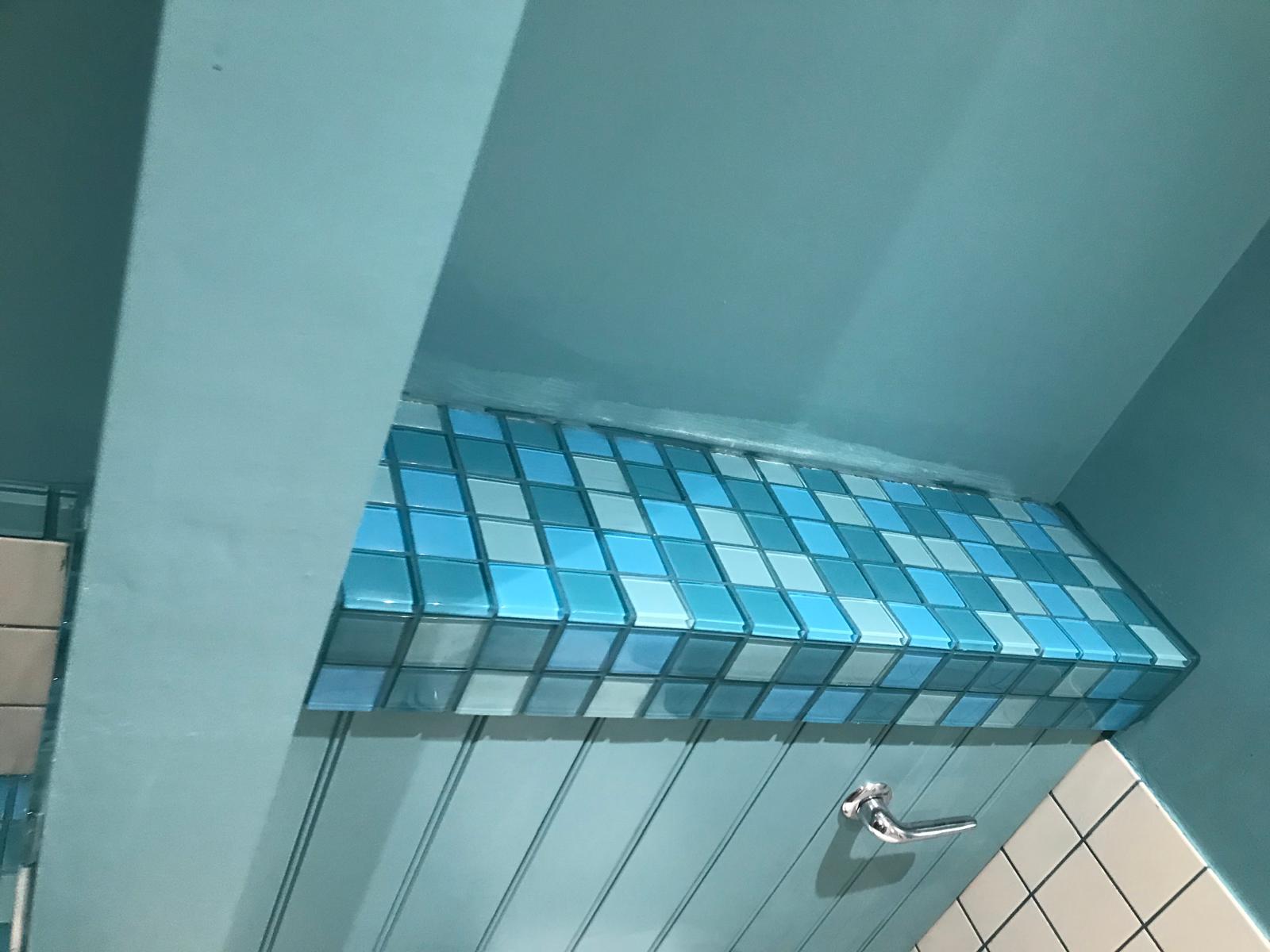 Complete blue mosaic tile on toilet top