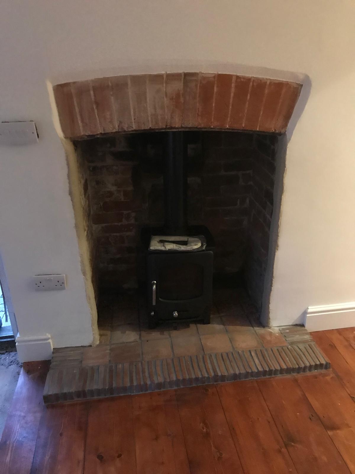 Complete terracotta tile installation in fire place for a project in Kent