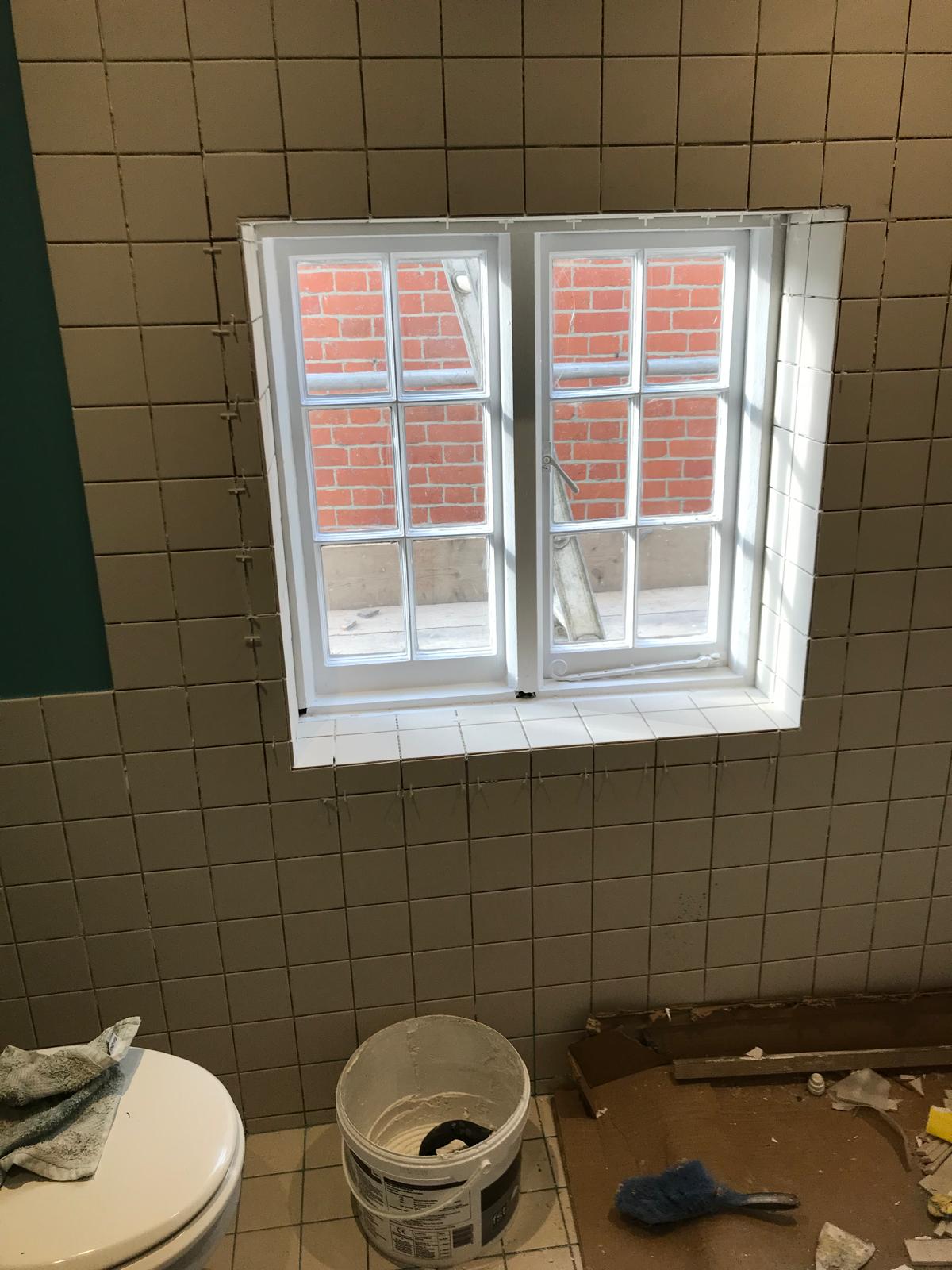 Complete wall white tiled installation