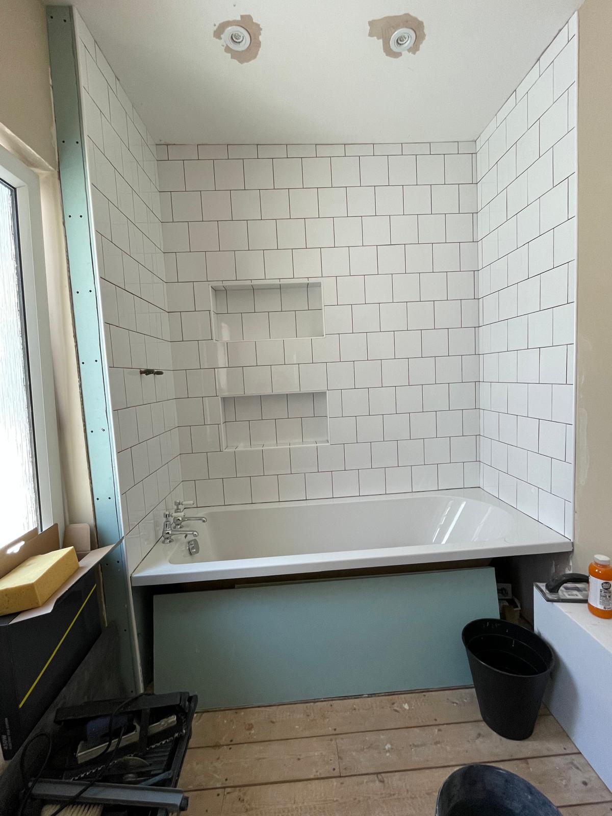 Completed wall tile installation above bath area for re-fit bathroom project in Kent 