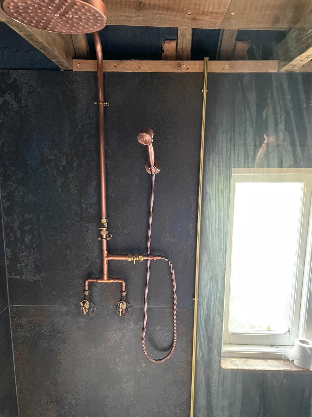 Copper wall shower installation with large tile installation for a bathroom project in Kent