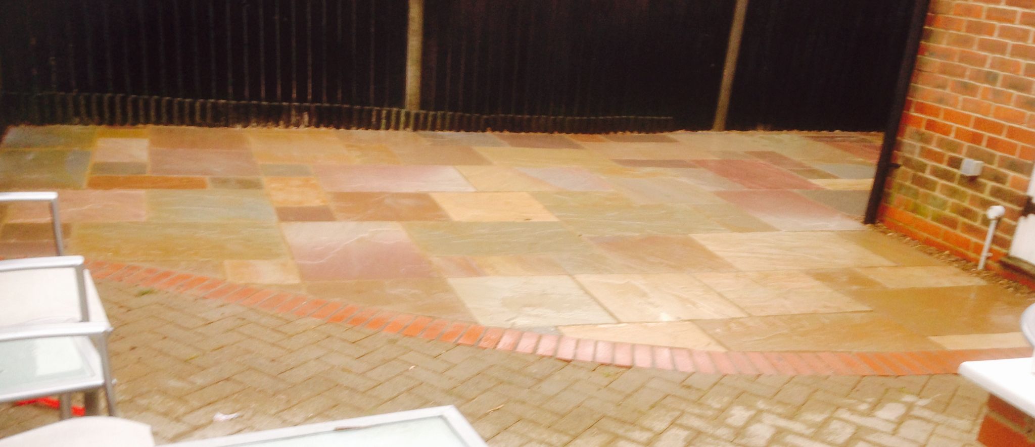 Curved multi coloured patio installed on a landscaping project