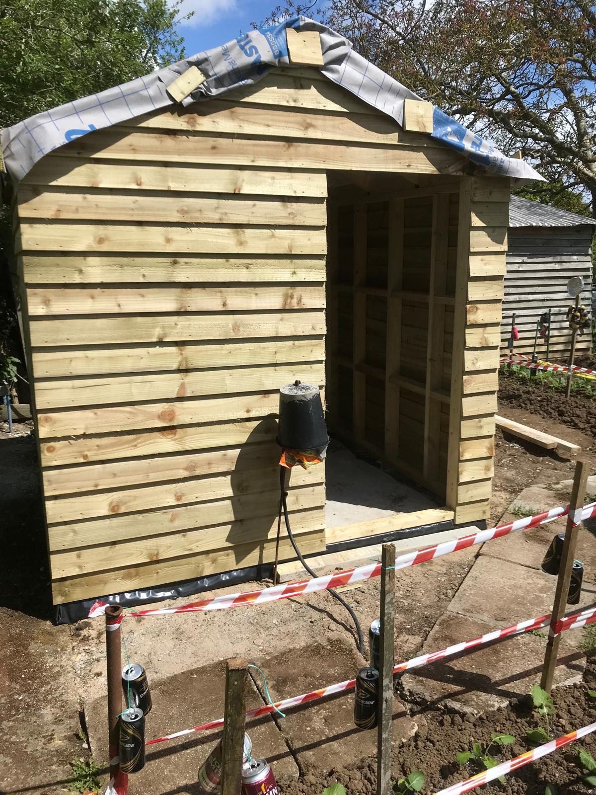 Custom shed build roof installation for a local landscaping project