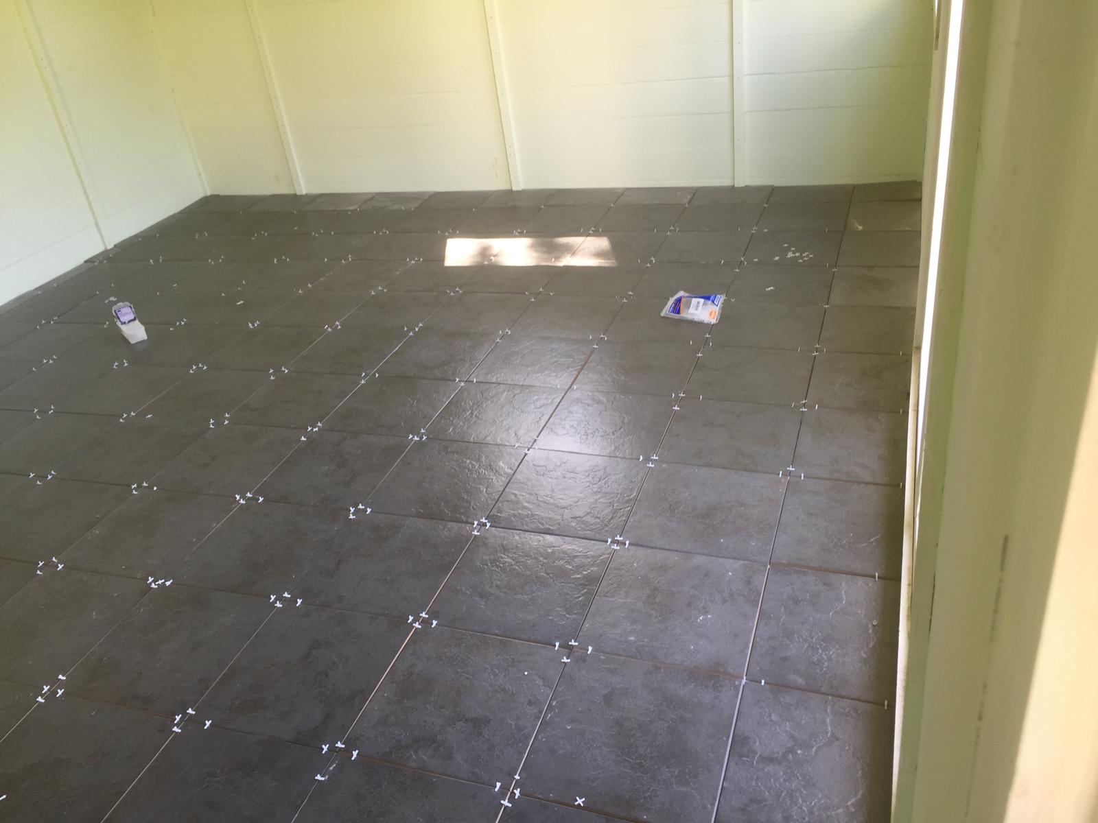 Dark grey floor tile installation for a local decorating project