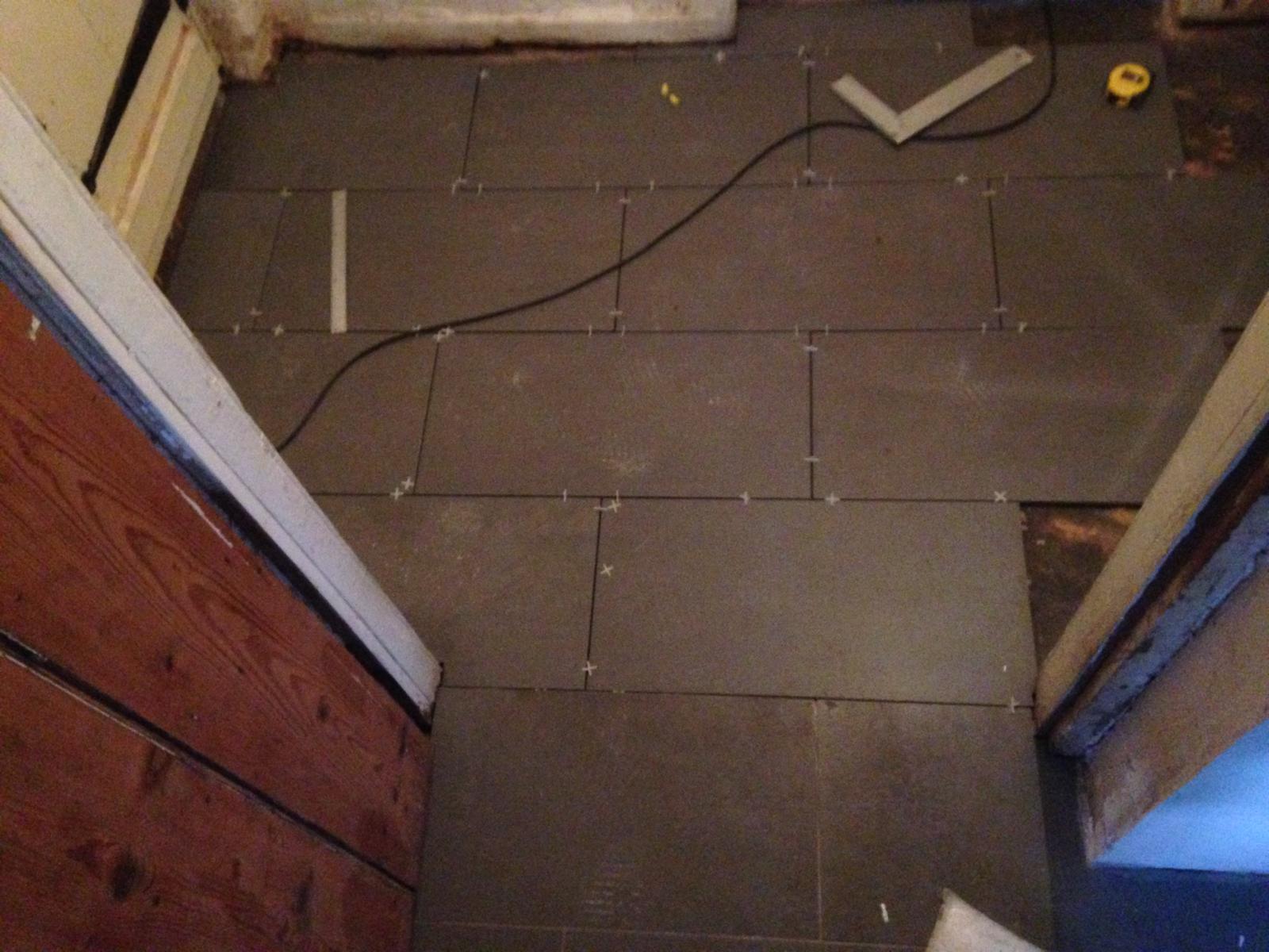 Dark grey floor tile installation