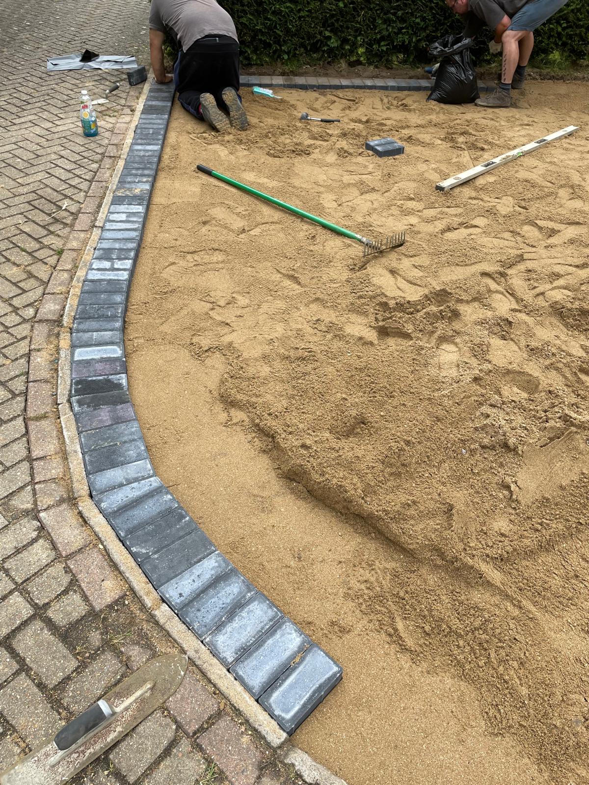 Dark grey out edge block paving for a driveway installation project