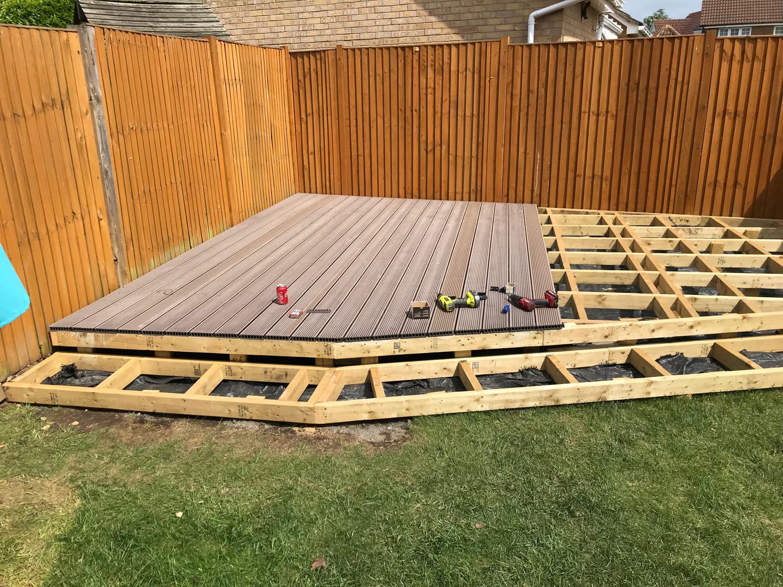 Deck board installation on a landscaping project in Kent