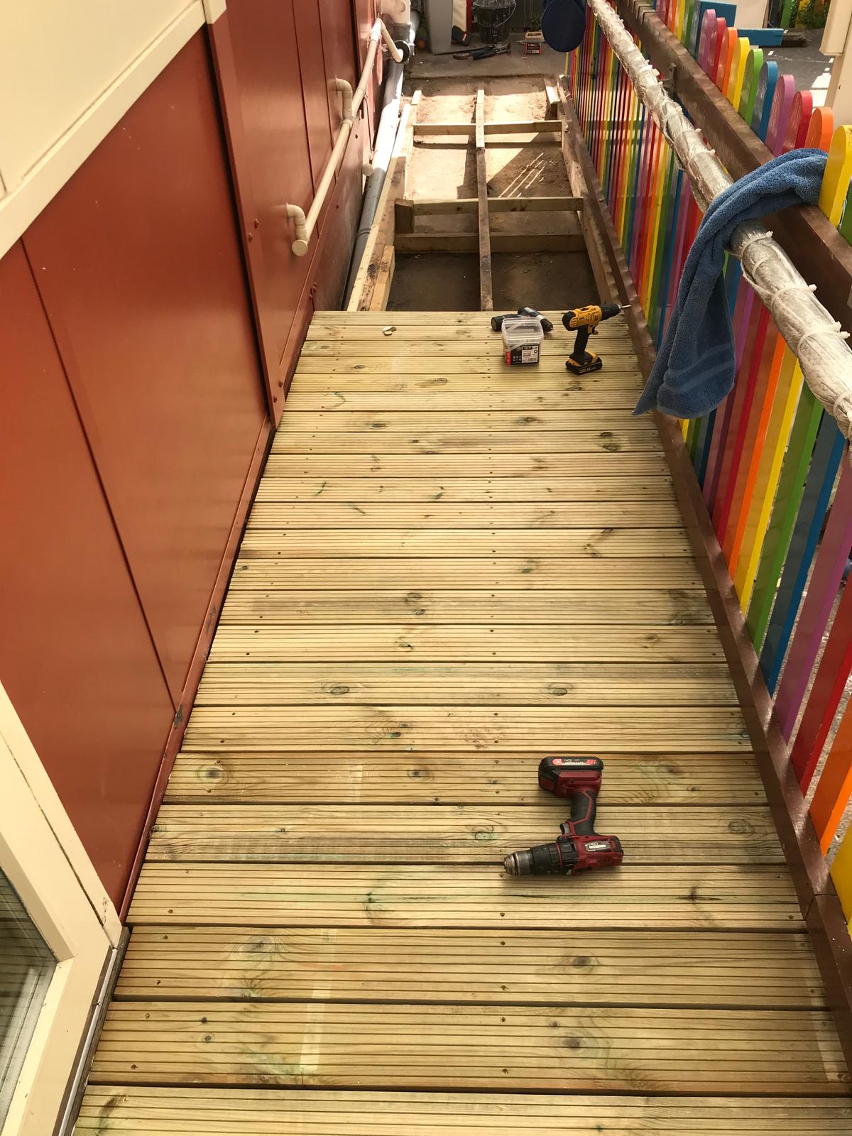 Deck board installation on a slope in a local nursery
