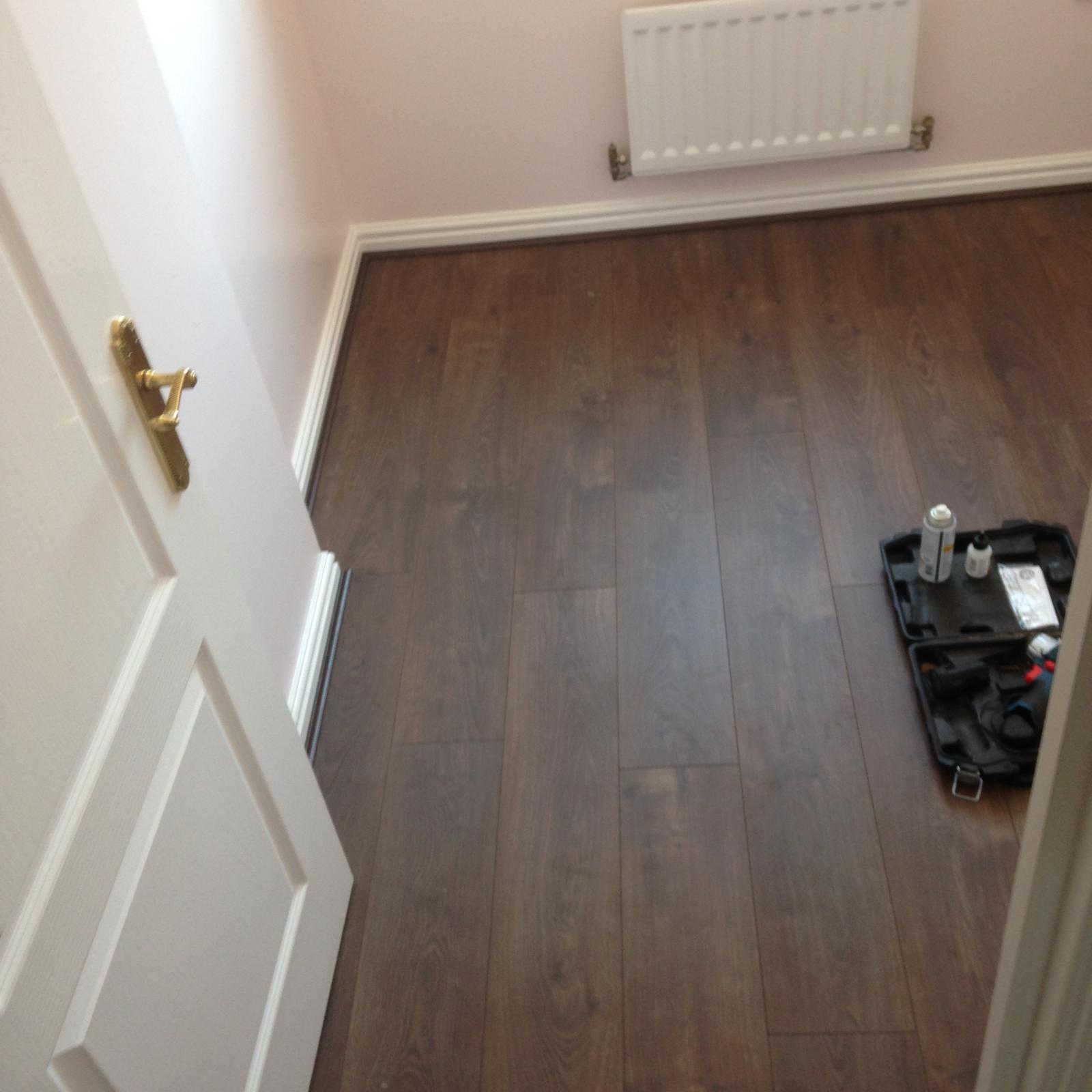 Decorating project with dark wood laminate floor installation
