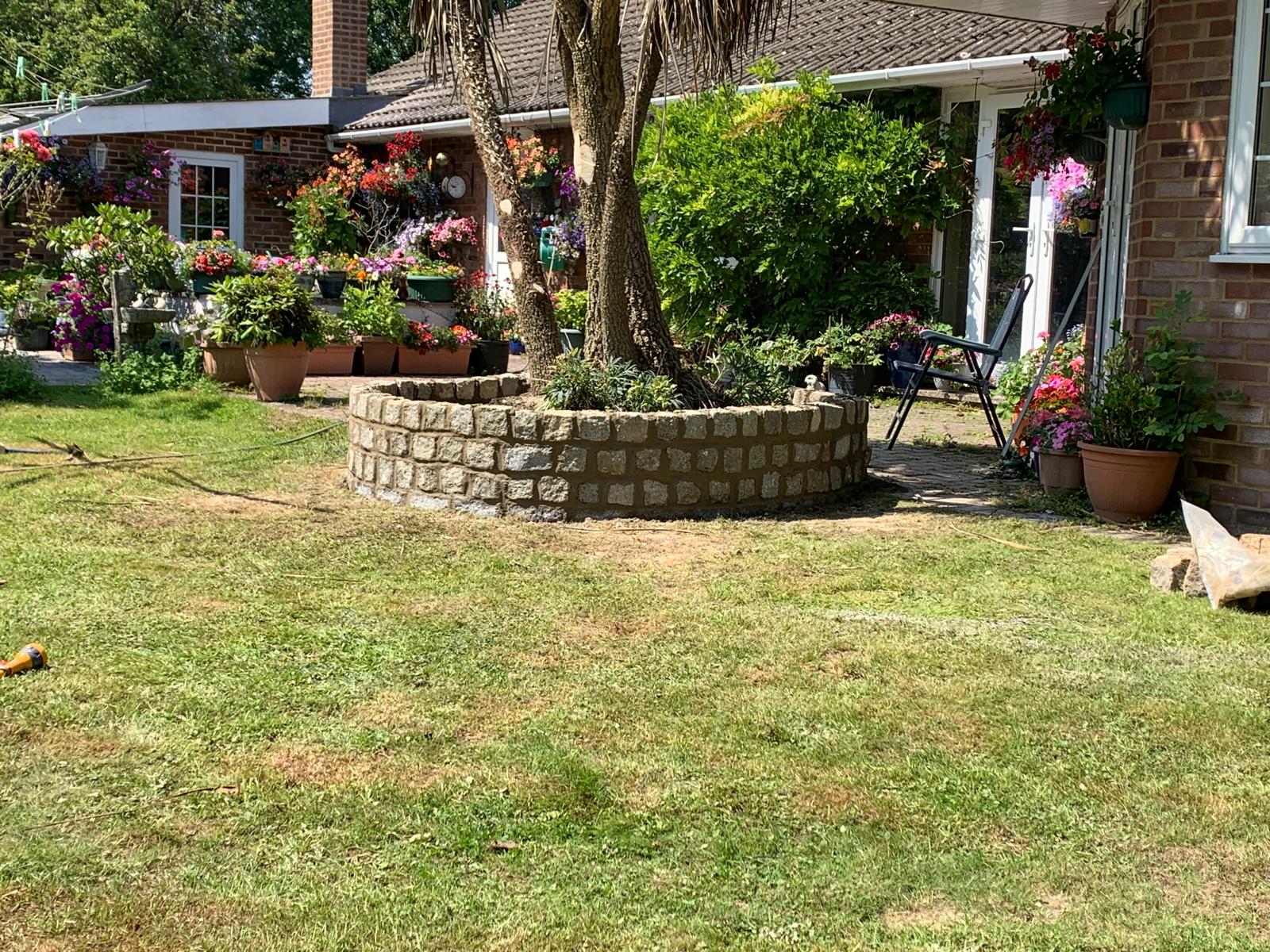 Decorative natural stone circle wall installation for a local landscaping project