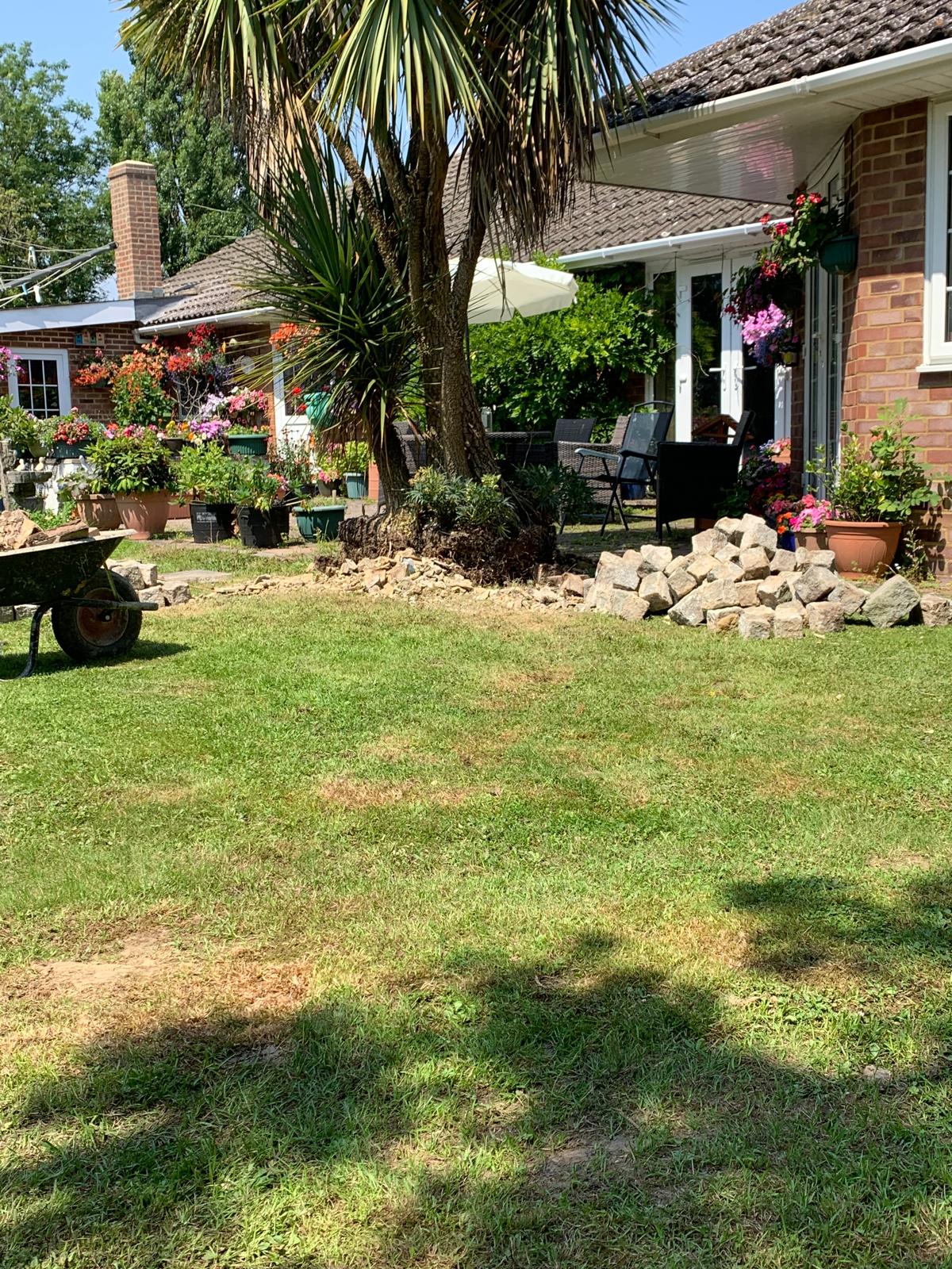 Decorative stone wall around a tree for a local landscaping project in Kent