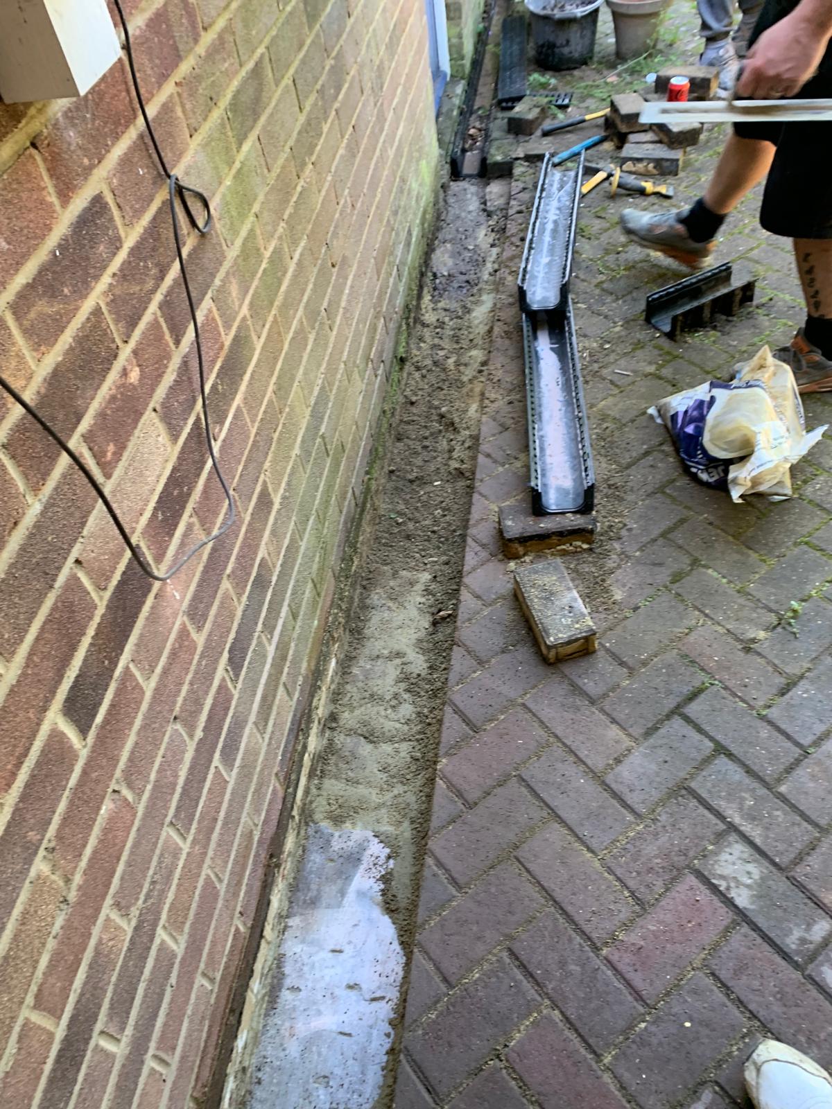 Drain installation next to block paving for a local project