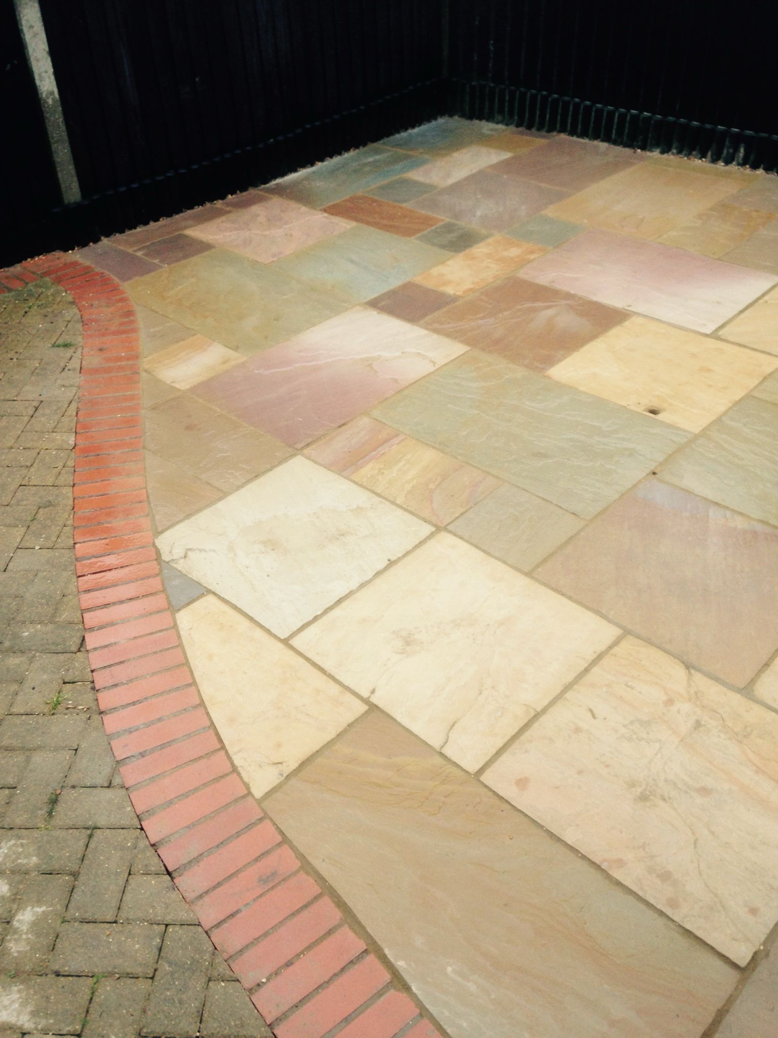 Edged curved multi coloured patio for a local project in Kent